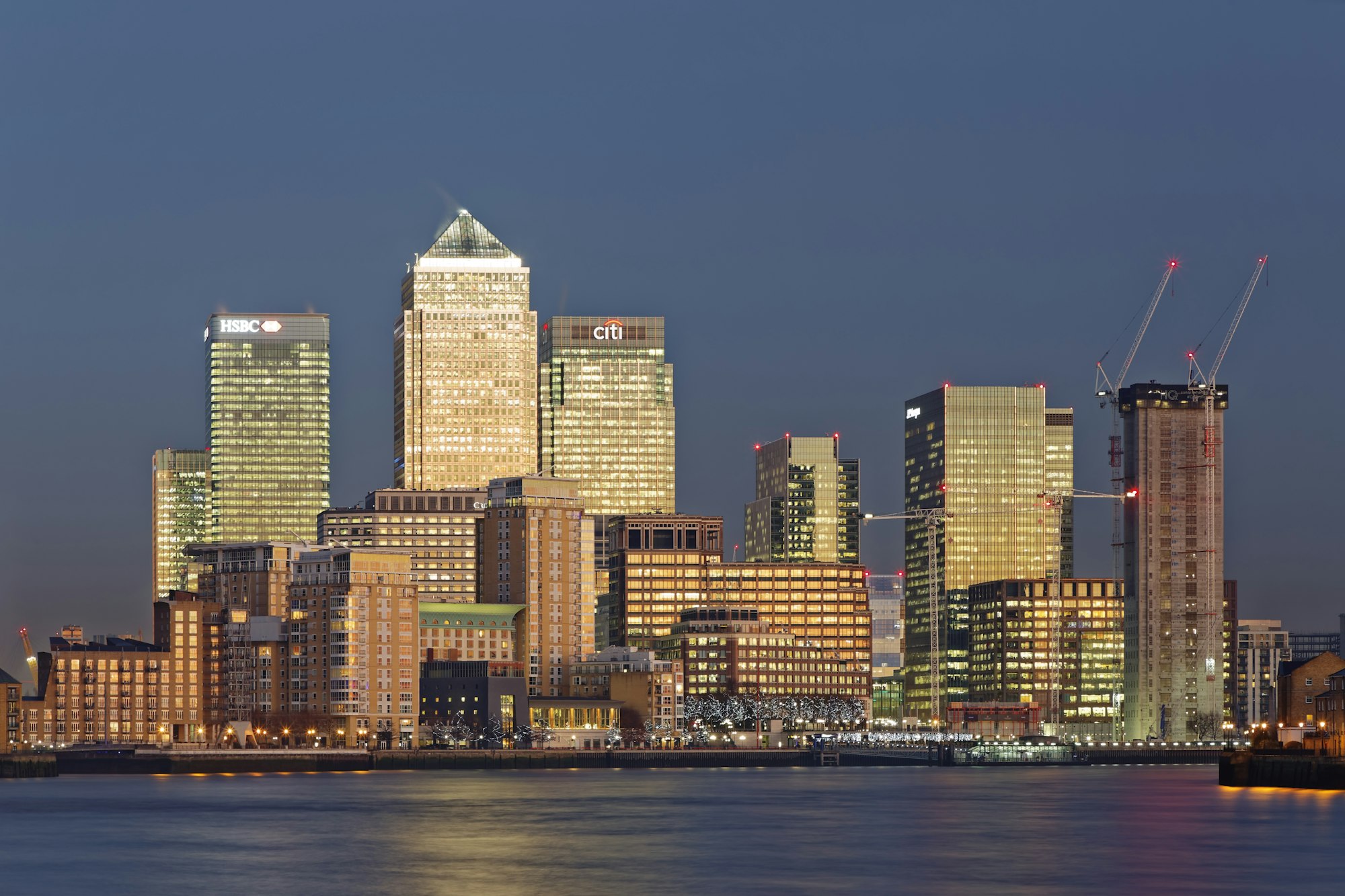 UK, London, skyline of Canary Wharf at River Thames at dusk